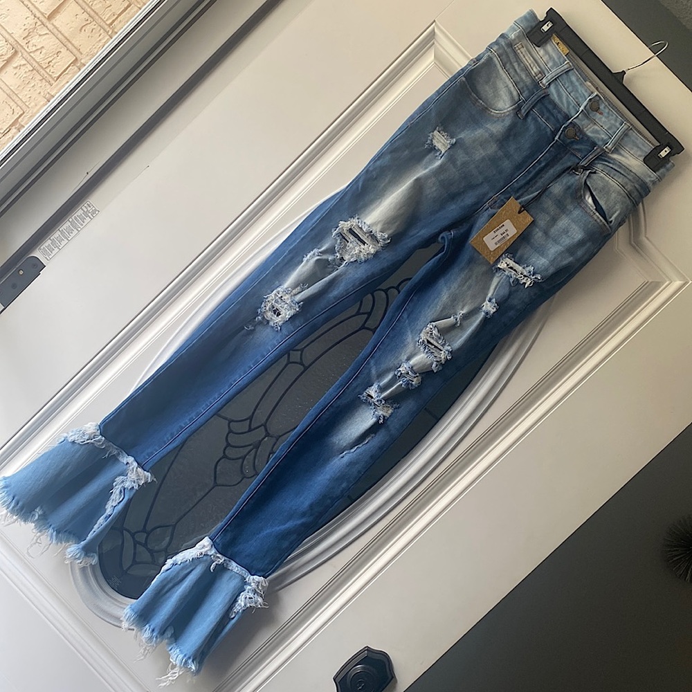 This are denim distressed bell bottoms jeans. They are a size 5 and stretchy.